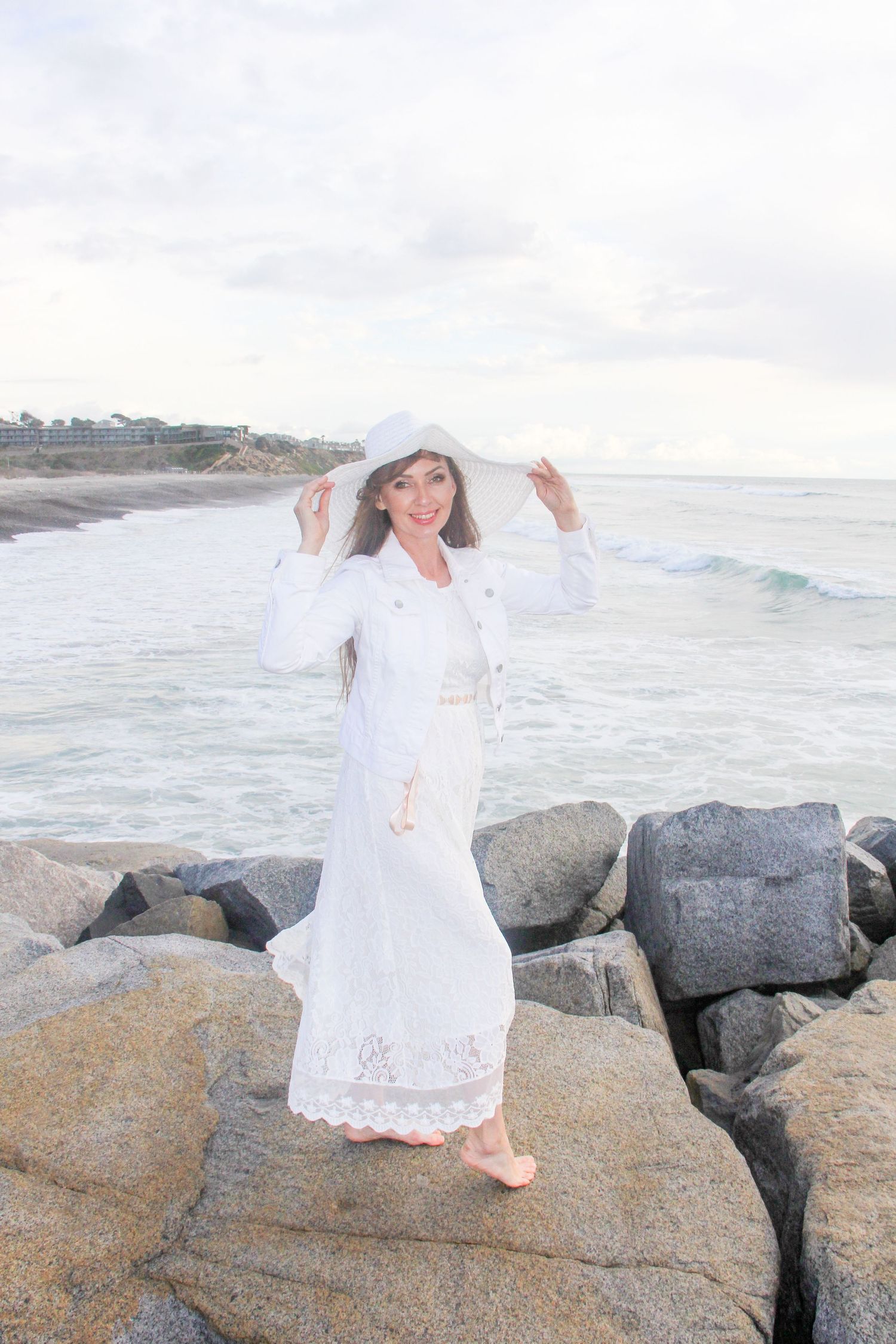 woman wearing a white hat at the beach
