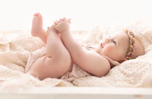 Close-up series of soft, delicate baby detail photos in gentle pink tones.