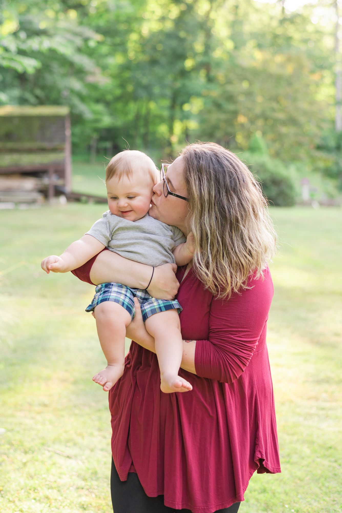Mom holding baby and kissing cheek in Mars, Pennsylvania