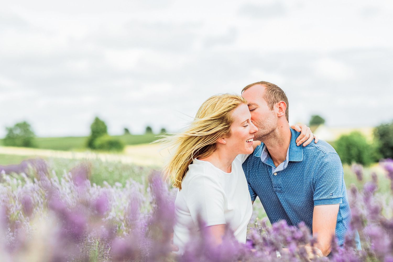 Hayley Elizabeth Photography Cotswolds Photographer Lavender engagement session Snowshill man kissing fiancé's cheek
