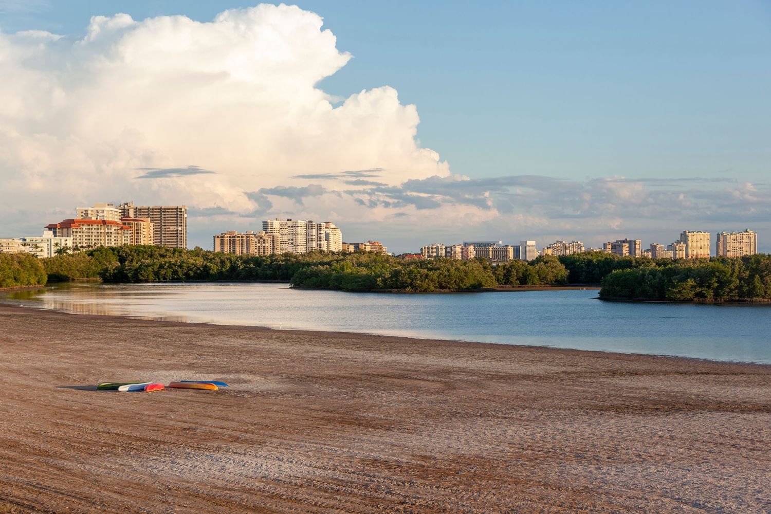 view of Tigertail Beach Lagoon, nature habitat and high-rises in the distance under an evening sky on Marco Island, Florida