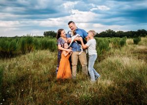 A beautiful family session with a family with their dog in a field in Orlando, FL.
