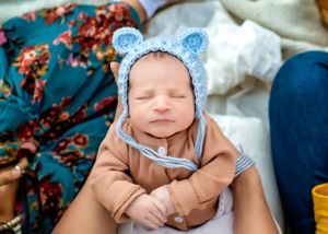 A newborn baby sleeping during an outdoor golden hour family session in Orlando, FL.
