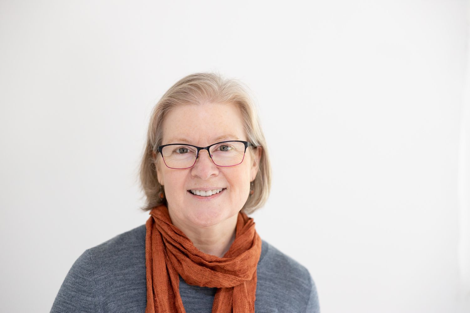 woman headshot in Woodinville, WA wearing burnt orange scarf