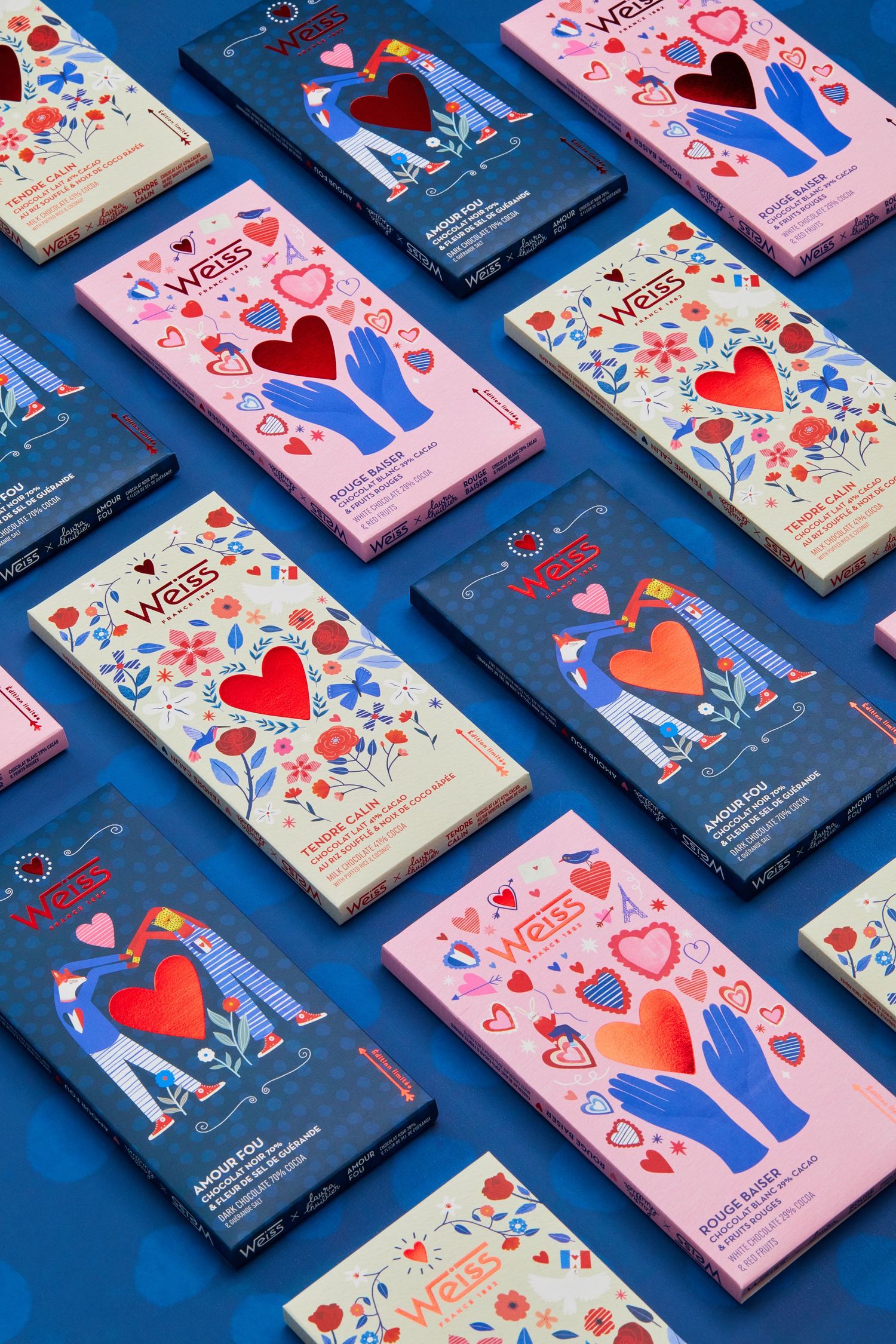 Valentine's themed chocolate bars with heart designs arranged in pattern on bright blue background.