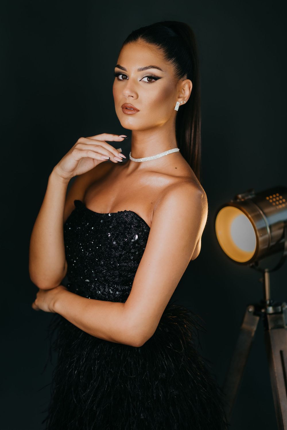 Glamour portrait with black sequined dress and studio lighting.