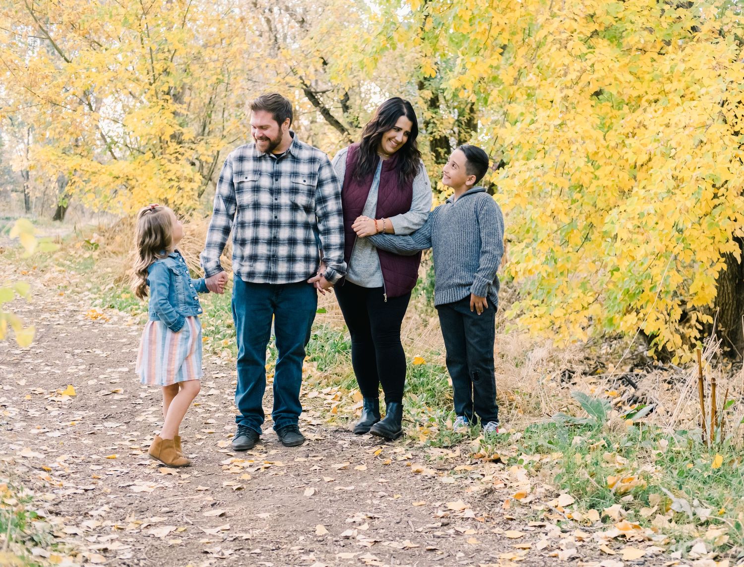 fall family in Kaysville Utah on the Gaily Trail in Davis County walking and laughing.