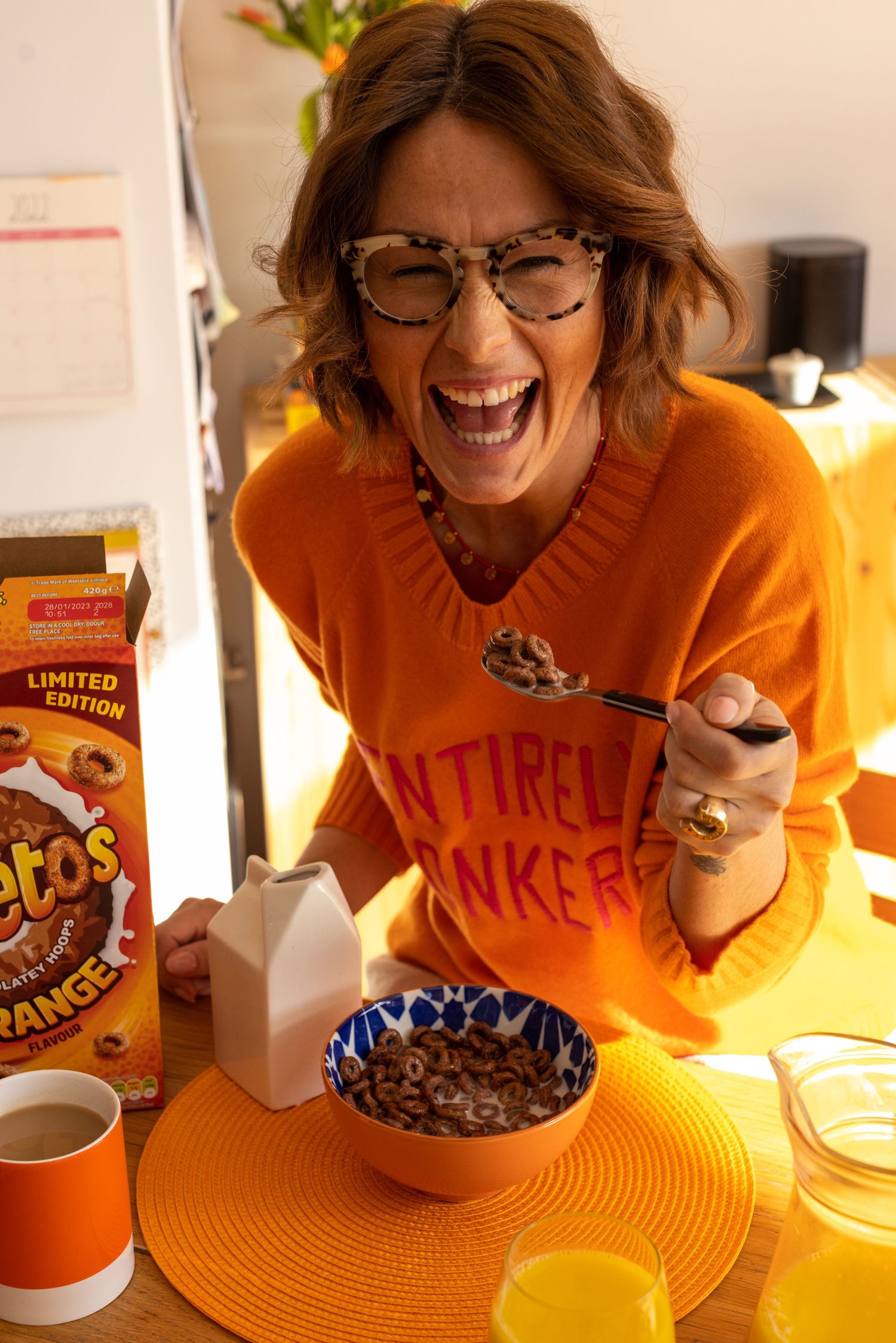 Sussex influencer model laughing over a bowl of Weetos for Instagram content, warm toned to match the product placement.