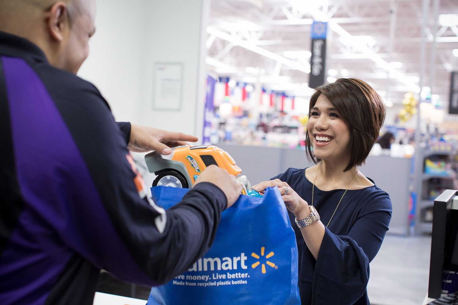 A  shopper takes ships her purchases from a FedEx Office location inside her local Walmart.