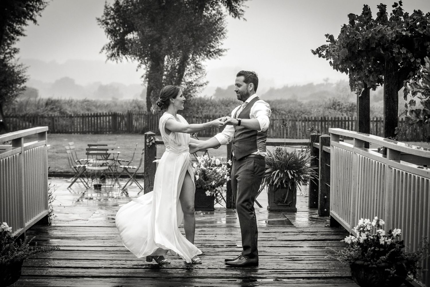 Series of black and white photos showing a couple on a wooden deck outdoors.