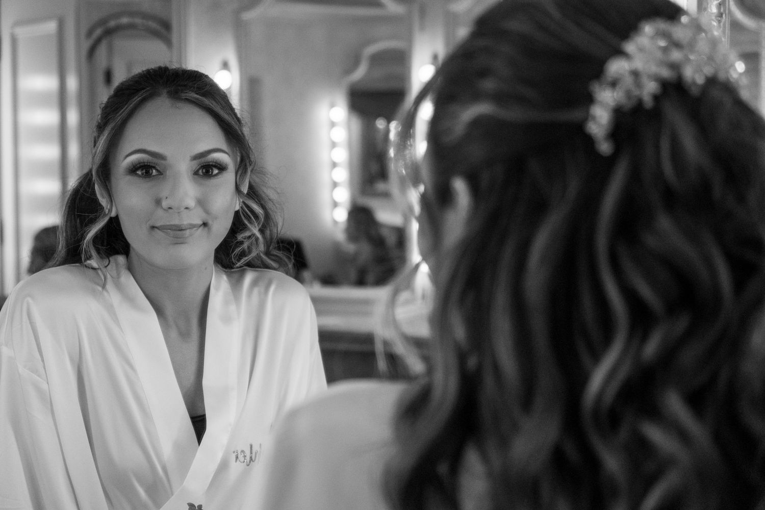 A reflection in a mirror shows preparation moments before a special event.