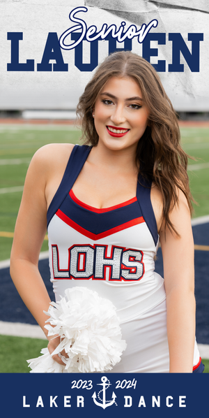 High school senior dance team member in white and navy uniform with red trim poses with pom pom on football field.