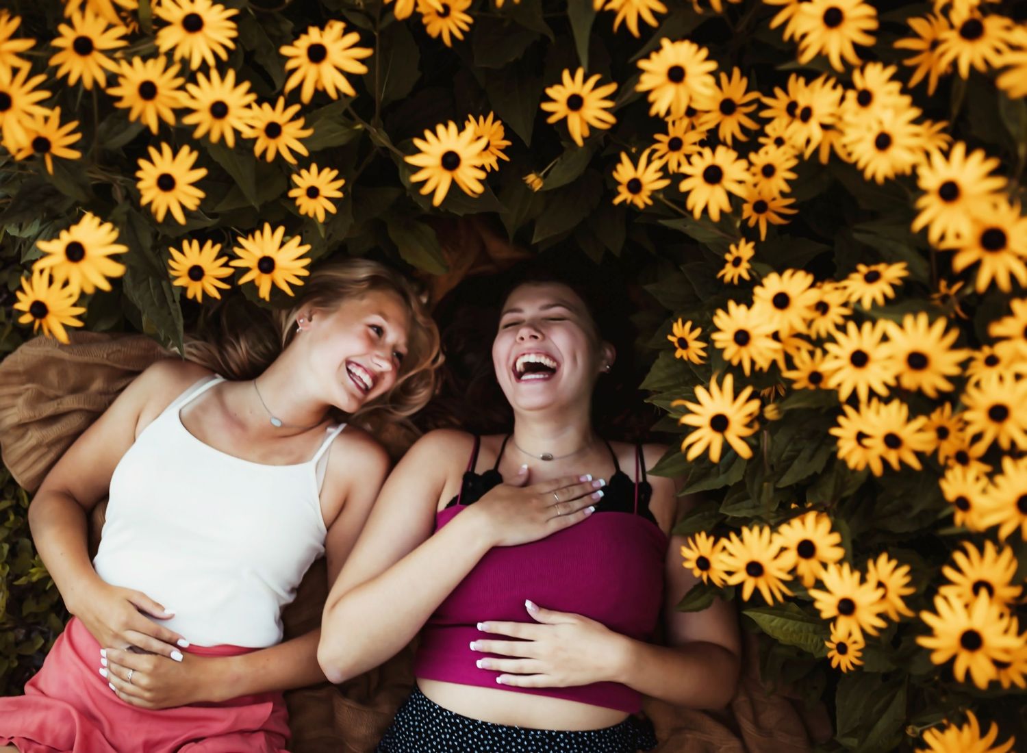 friends laying in flowers laughing, delafield wisconsin