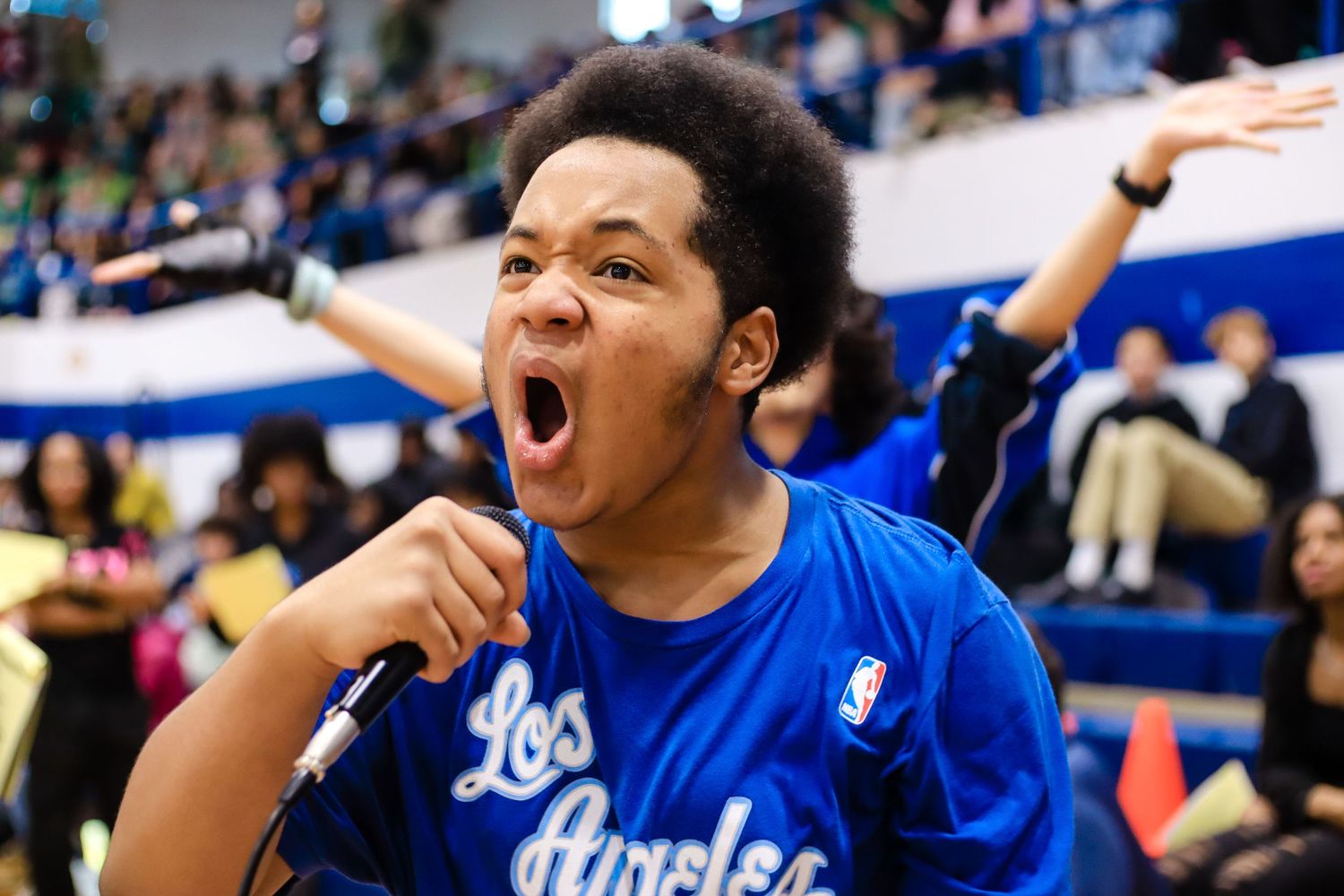 Boy yelling into mic at high school event