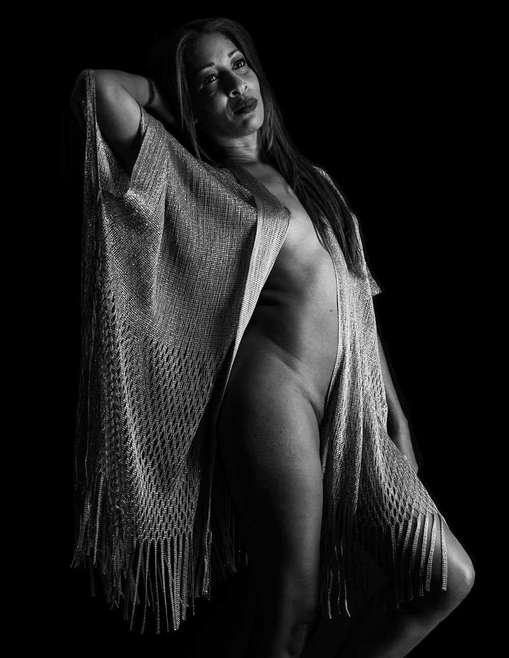 Black and white portrait featuring fringed shawl with dramatic lighting.