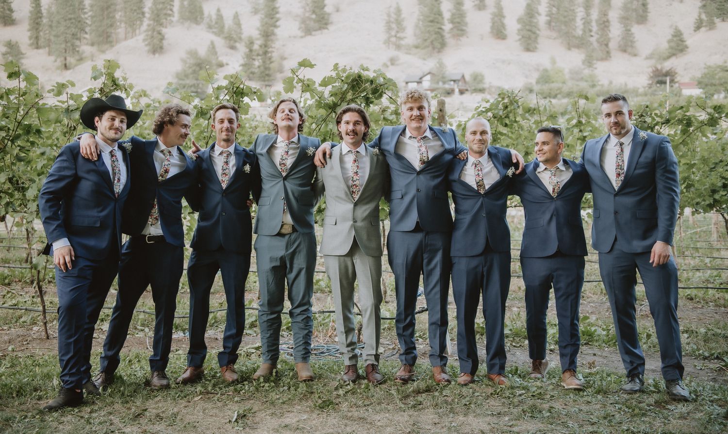 Groom next to all of his grooms men for formal wedding party photos in Kelowna.