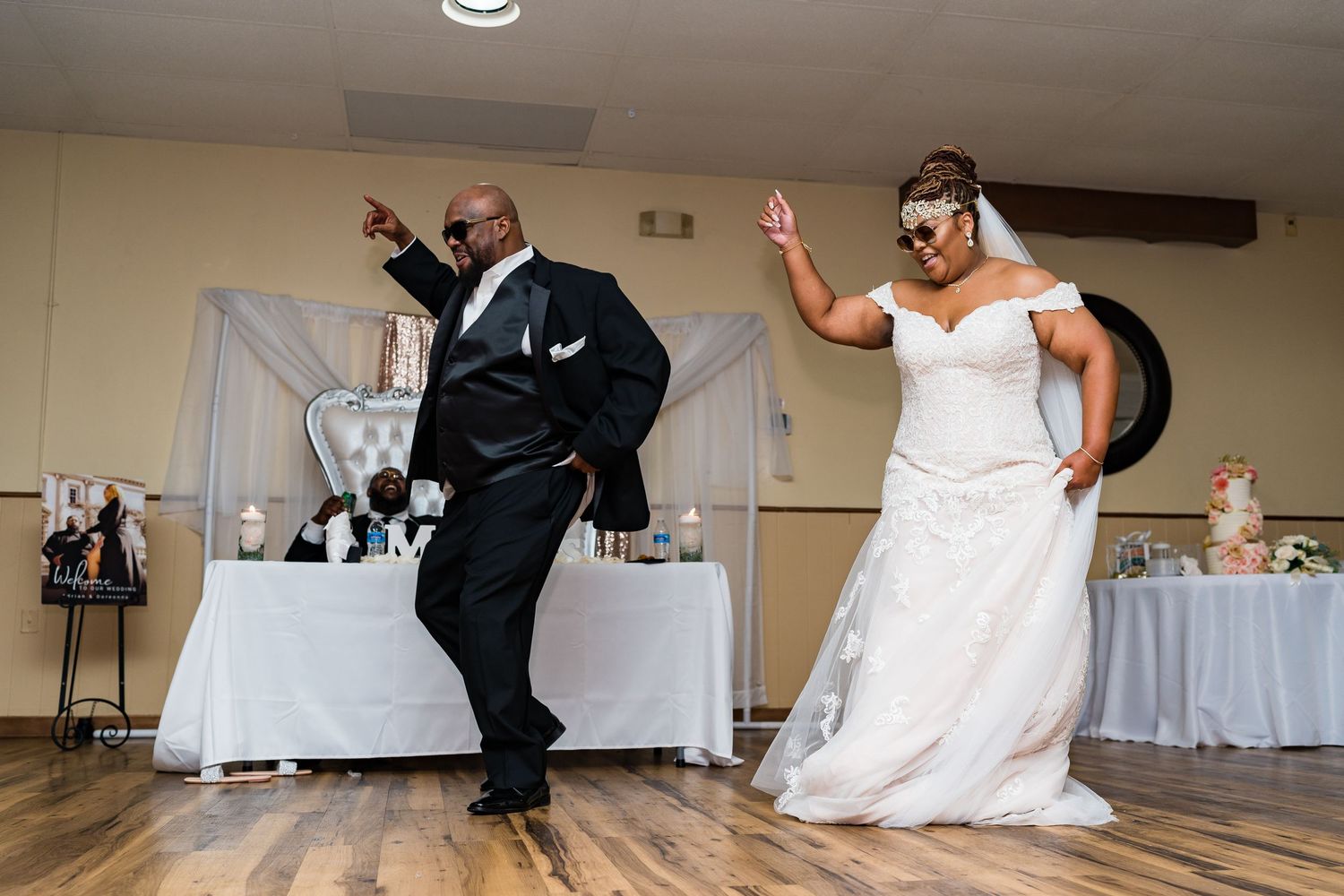 Newlyweds performing energetic dance moves during their wedding reception.