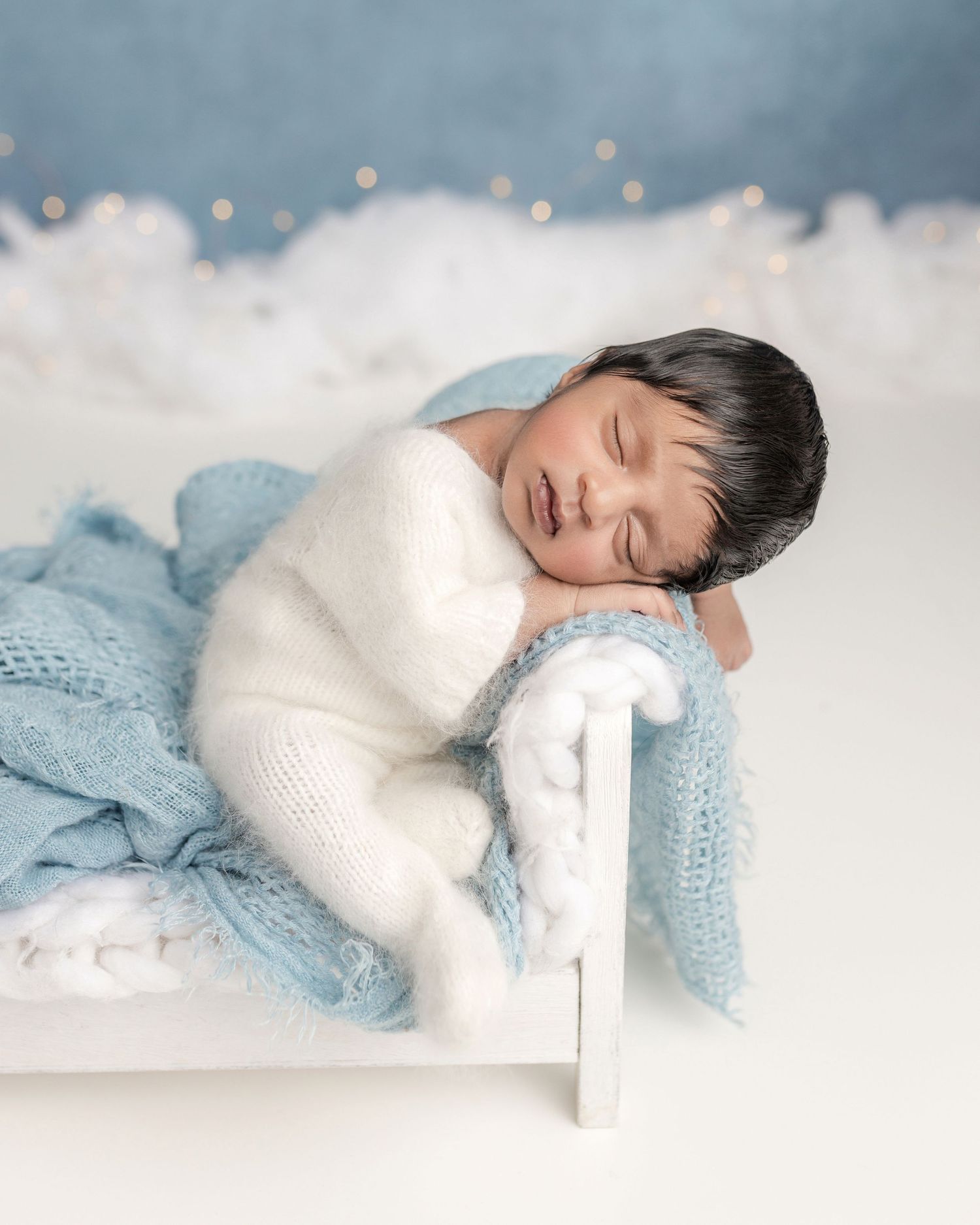 newborn photos baby on the bed cork