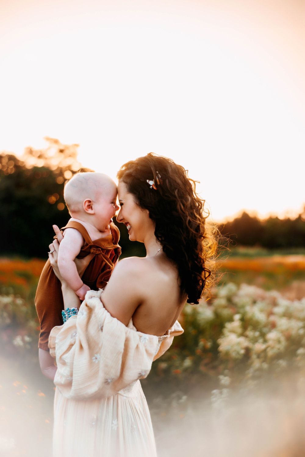 A series of ethereal sunset photos showing tender moments in a wildflower field.