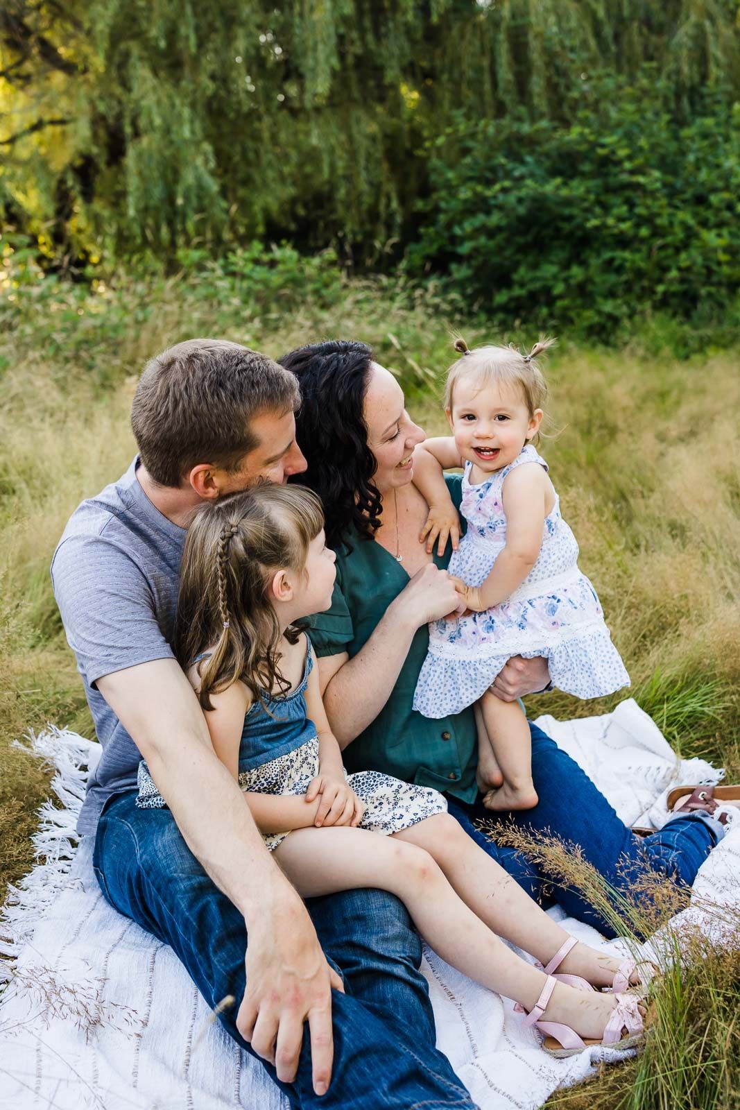 Summer family photos outdoors on a blanket.