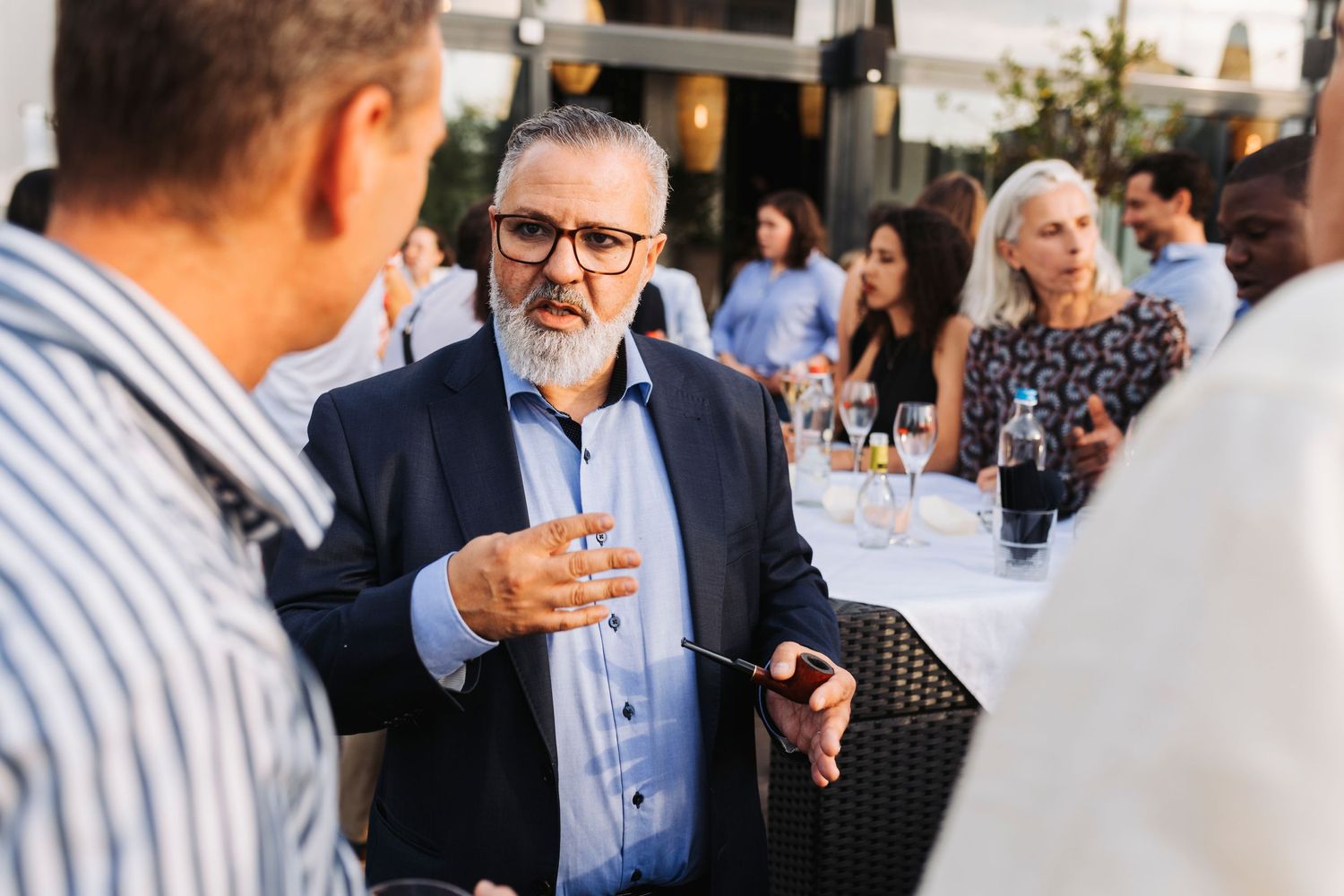 A business conversation between professionals during an outdoor networking event.