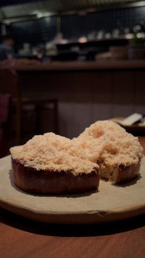 Two chocolate desserts with crumb topping served on a rustic ceramic plate.