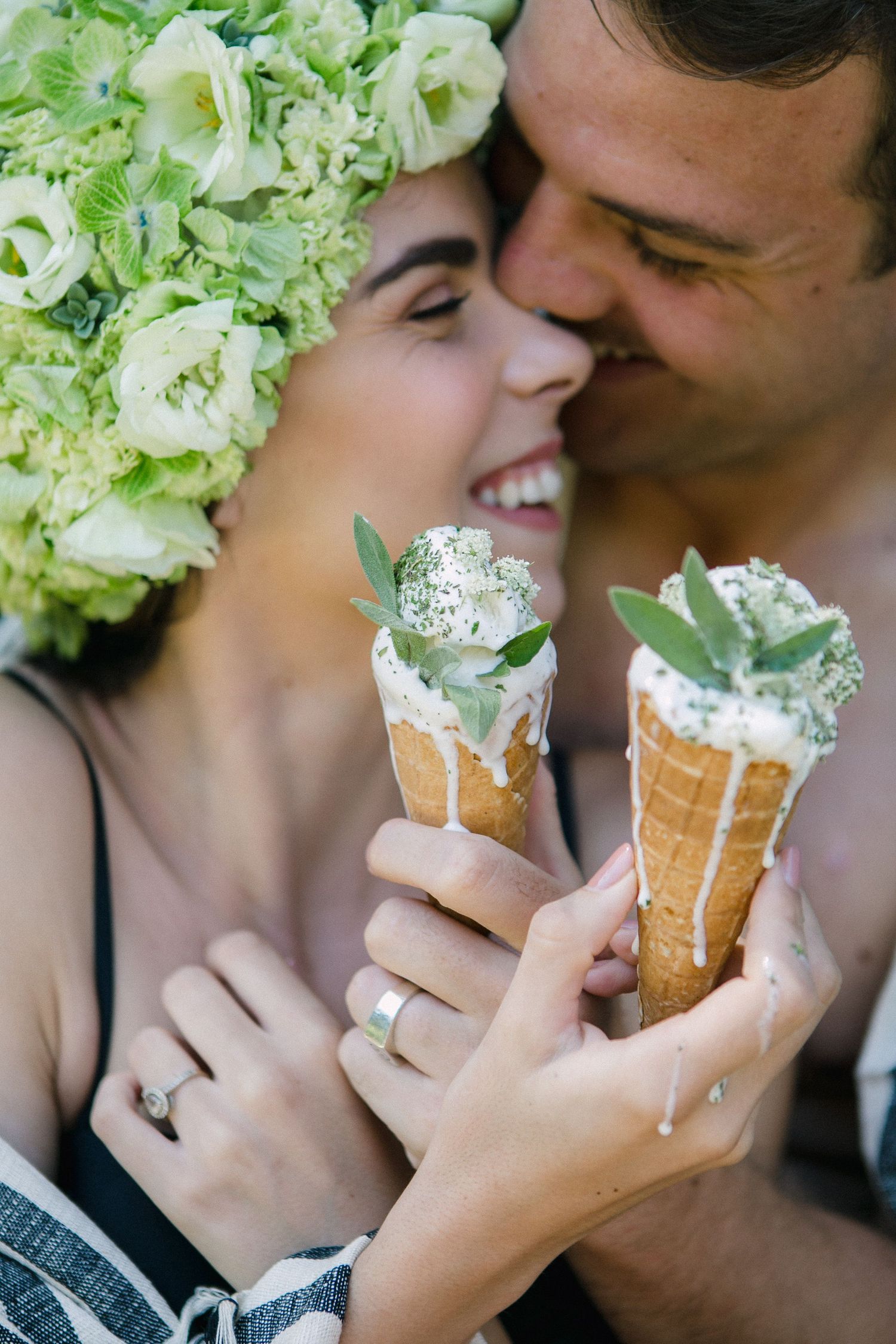 Dripping ice cream on a hot summers day with a couple kissing in the background.