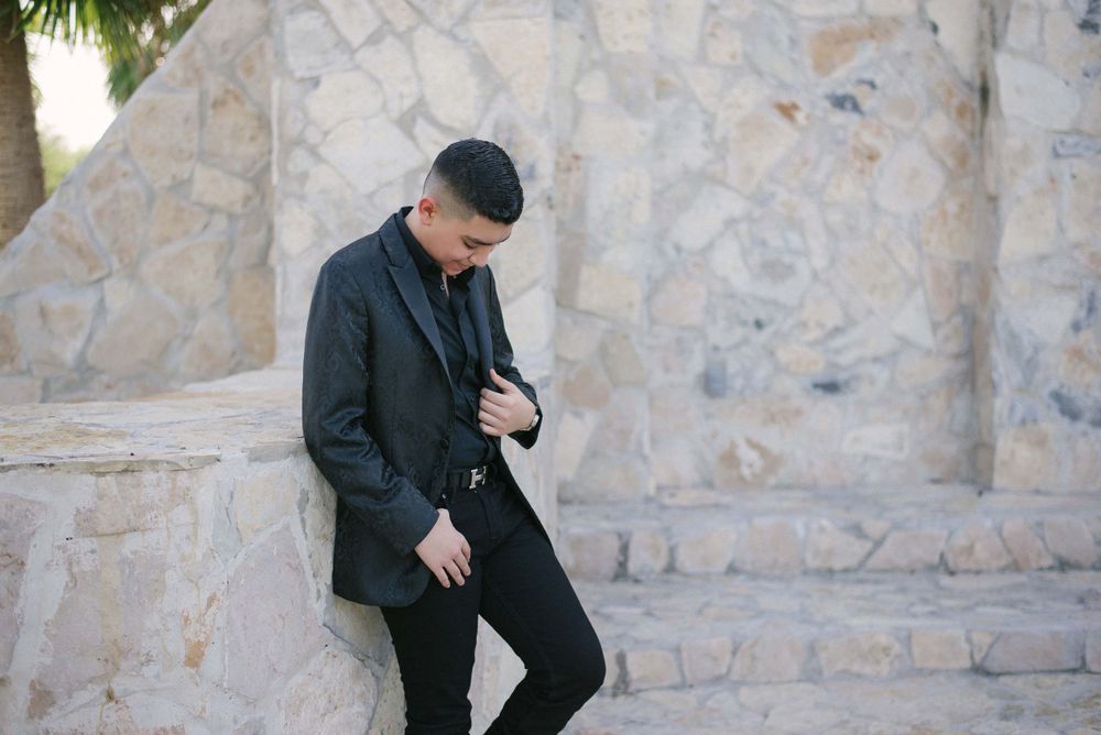 model holding his jacket with one hand. boy celebration. McAllen wedding photographers