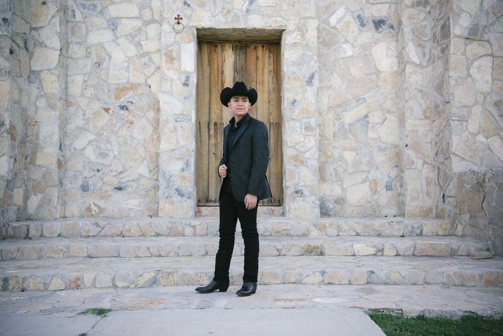 quinceanero wearing a hat a his photo session. McAllen wedding photographers