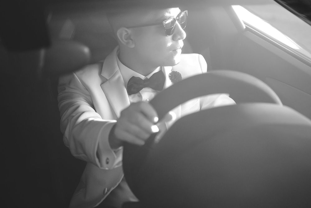 man driving a luxury car at south padre island, texas