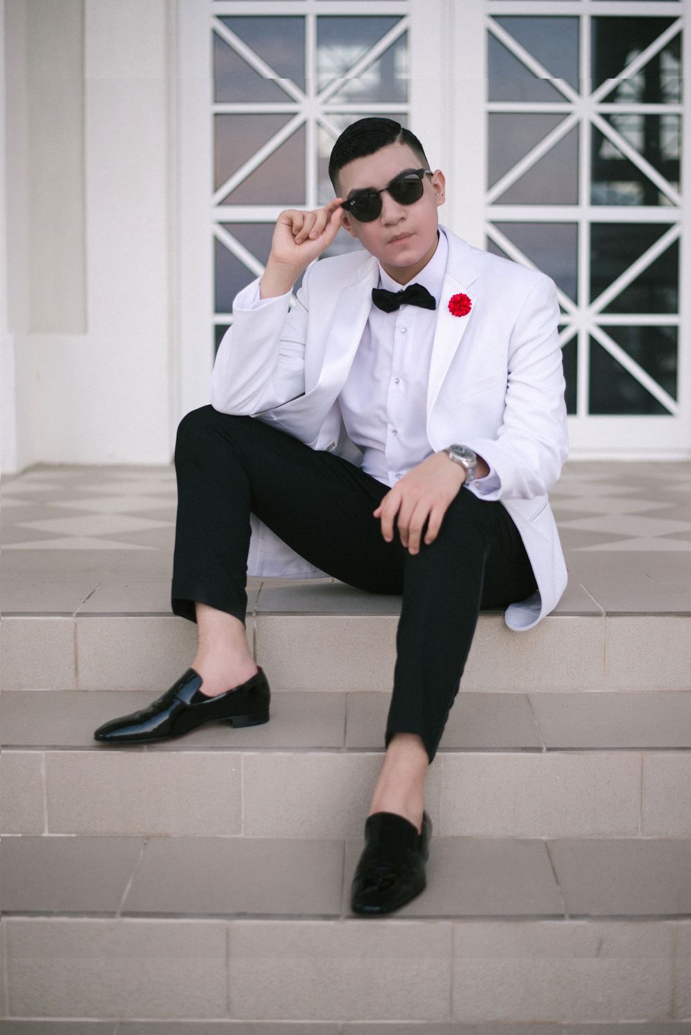modeling at his photo shoot holding sunglasses. modern photography. SPI, Texas