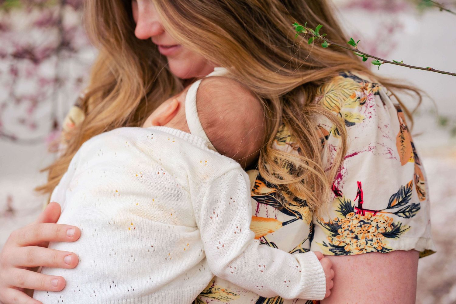 Mom holding and snuggling newborn girl