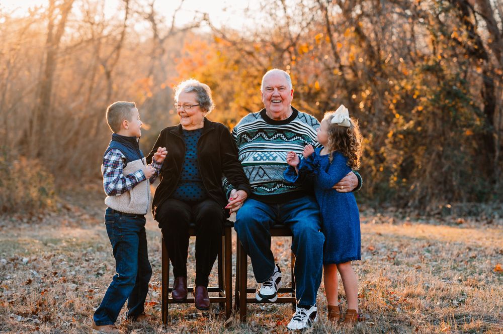 great grandparents with 2 grandchildren smiling during dallas area sunset extended family photo session outdoors
