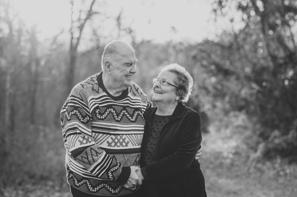 black and white portrait great grandparents smiling together at camera during dallas area extended family photo session