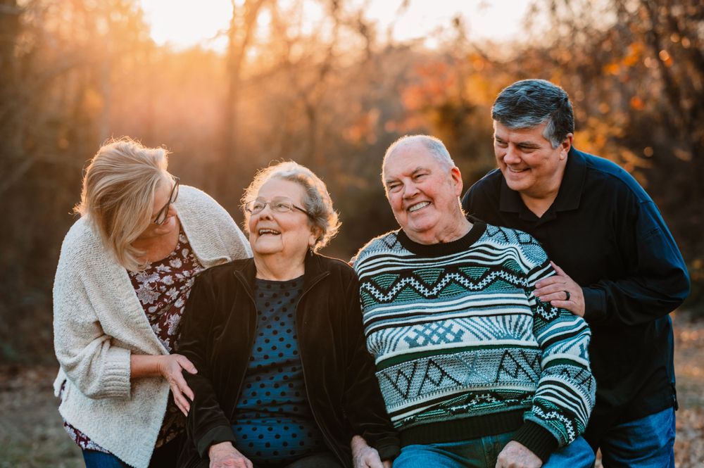 grandparents take photo with adult children during dallas area sunset extended family portrait session outdoors