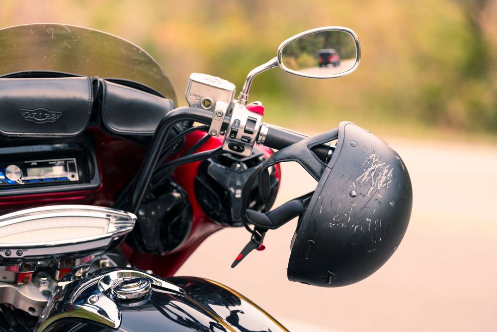 Motorcycle helmet and mirror mounted on vintage-style bike.