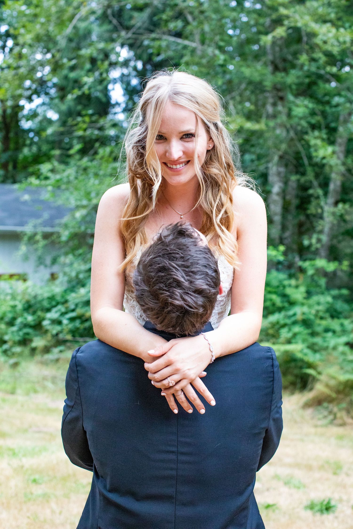 A playful wedding photo captured outdoors with a couple in a fun, candid moment.