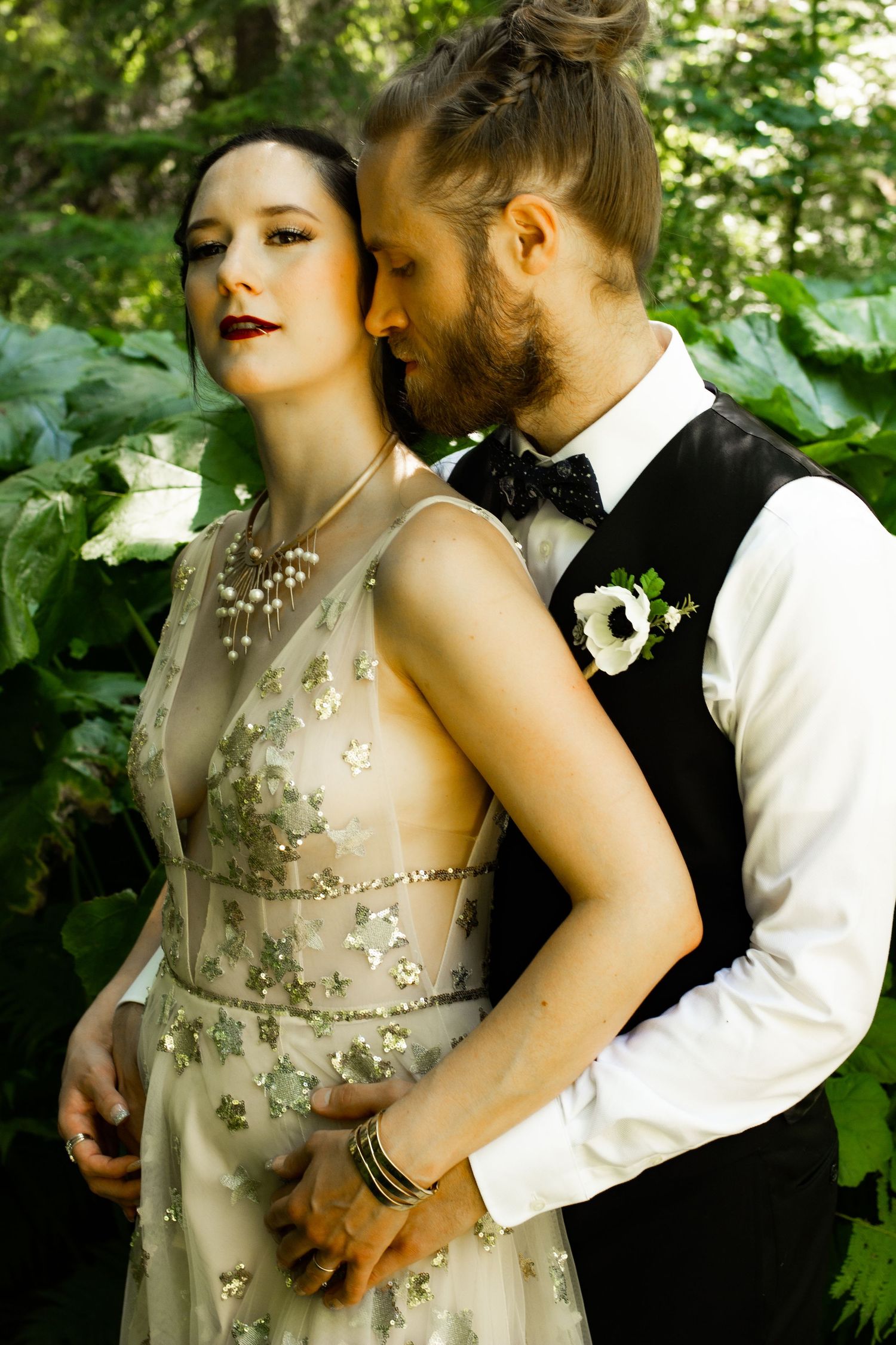 A romantic couple's portrait with the bride in a beaded champagne gown and groom in formal attire.
