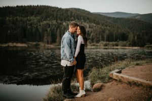 Scenic mountain engagement photos with lake and forest views in background.