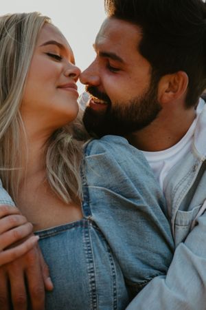 Intimate close-up portrait of couple in casual denim attire.