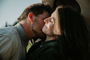 Intimate close-up photography of couple sharing romantic moment outdoors.