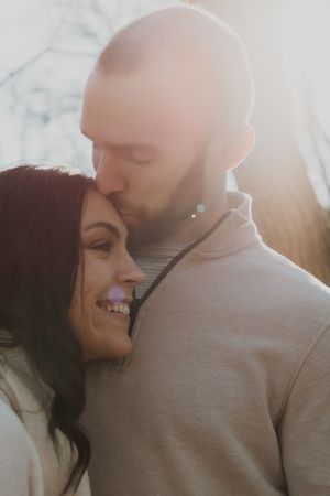 Sunlit close-up shots capture tender moments between a couple.