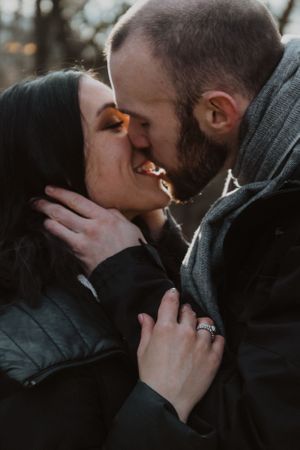 A romantic couple shares intimate kisses in a series of moody, dark photographs.