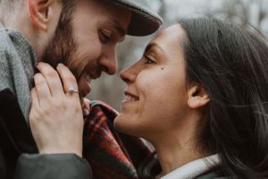 Romantic winter photoshoot showing intimate moments between a couple.
