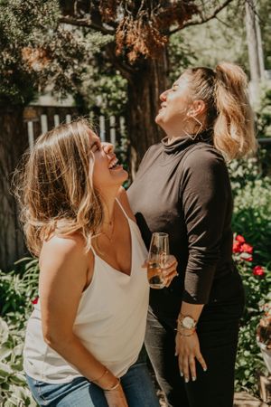 A couple enjoys playful moments together during an outdoor summer photoshoot.