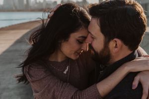 Intimate couple photography session with dramatic lighting and shadows.