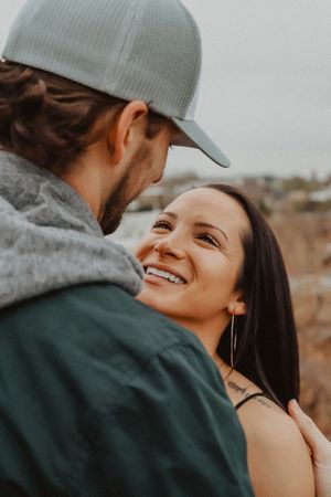 Close-up of a couple sharing an intimate moment outdoors with natural lighting.