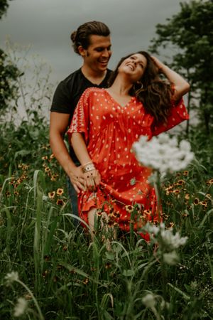 Romantic couple enjoying moments together in a field of wildflowers.