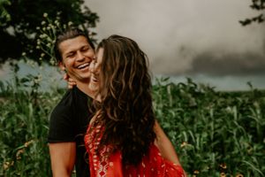 Candid moments between a couple during a sunset photoshoot in nature.