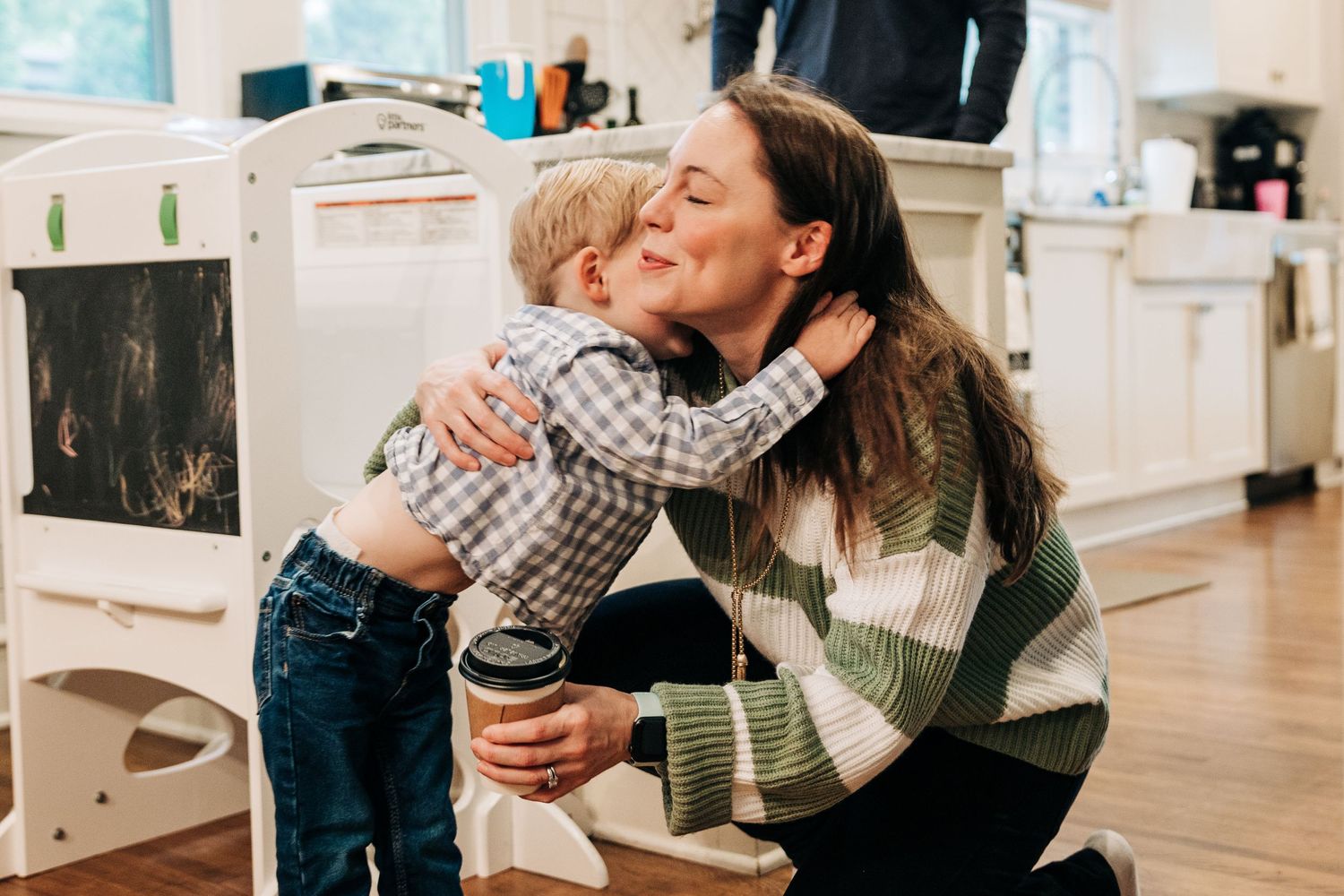 Mom and young son hugging in their Charlotte, NC kitchen